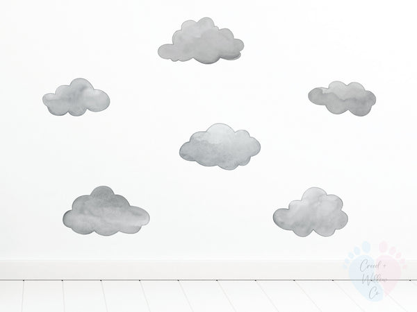 Pack Includes Six Dark Grey Cloud Wall Decals On a White Patterned Wall