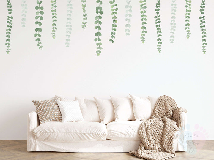 Hanging Vine Wall Decals Pack Showcasing White Couch With Pillows Against Leafy Vine Wall