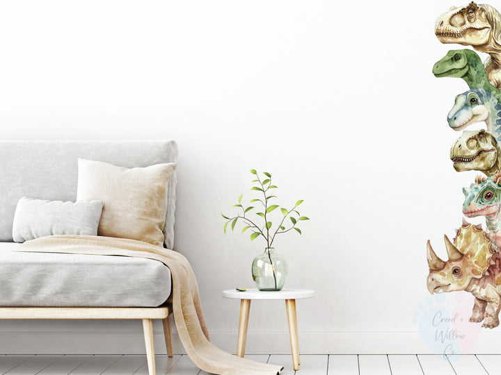 removable nursery wall decal with dinosaurs peeking from behind leaves and furniture