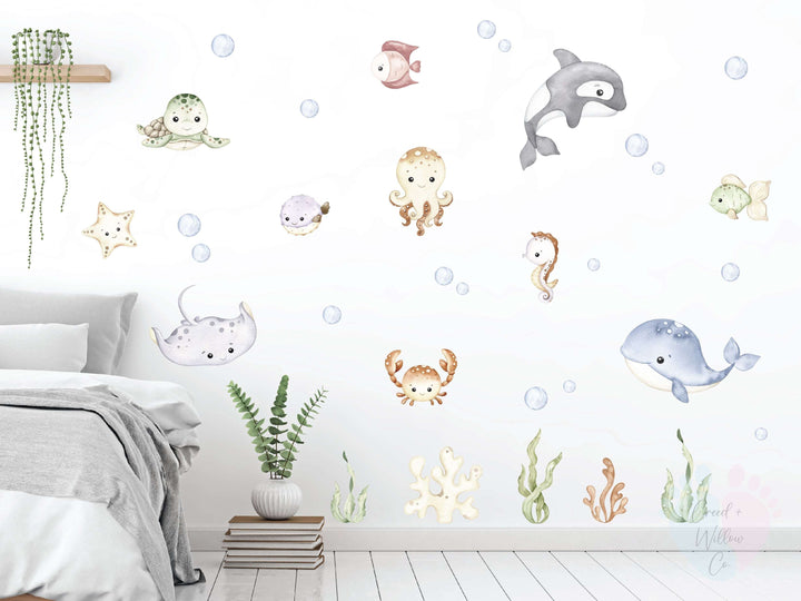 Applying Fish Wall Stickers From Sea Creature Wall Collection On a Blue Background